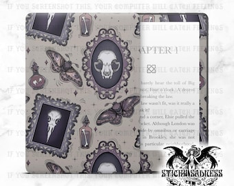 May include: A gray e-reader cover featuring a repeating pattern of framed skulls, moths, and potion bottles. The cover is open, displaying the e-reader screen with book text. The cover has the text "IF YOU SCREENSHOT THIS, YOUR COMPUTER WILL CATCH FEELINGS".