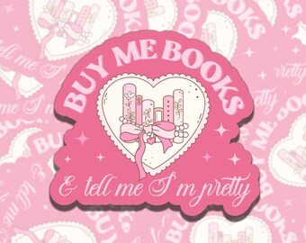 May include: Pink sticker with a heart-shaped design featuring a stack of books with a bow. The text "Buy Me Books & Tell Me I'm Pretty" is written in a whimsical font.