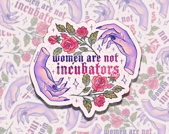 May include: A sticker with a floral design and the text "women are not incubators." The sticker features two hands in a purple hue, with black nail polish, surrounding a floral arrangement of red roses and green leaves.