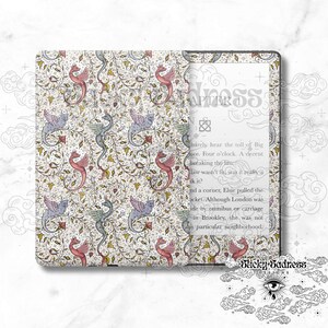May include: A Kindle e-reader with a white and gold cover featuring a repeating pattern of stylized dragons and floral designs. The text "Chapter 1" is visible on the screen.