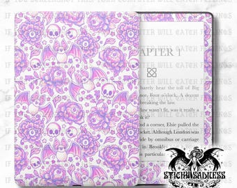 May include: A white e-reader cover featuring a repeating design of purple bats, skulls, flowers, and eyeballs. The open cover displays the e-reader screen with text. The cover has the text "IF YOU SCREENSHOT THIS, YOUR COMPUTER WILL CATCH FEELINGS".