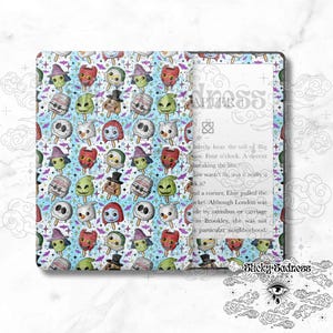 May include: A light blue patterned book cover featuring a repeating design of spooky ice pops with various faces. The book cover has the word "Sadness" and the text "Chapter" printed on it.