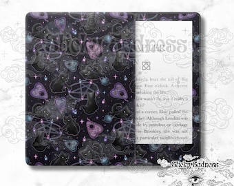 May include: A black and purple Kindle Paperwhite e-reader cover featuring a pattern of black cats, pentagrams, and clouds. The text "Sticky Sadness Designs" is visible in the bottom right corner.