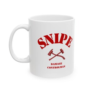 May include: White ceramic mug with a red design. The design includes the word "SNIPE" in a curved font, with crossed axes below and the words "DAMAGE CONTROLMAN" underneath.
