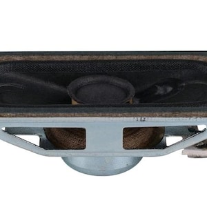 May include: A small, rectangular speaker with a black cone and a silver metal frame. The speaker has a brown foam surround and two metal terminals. The speaker is designed for use in electronic devices.