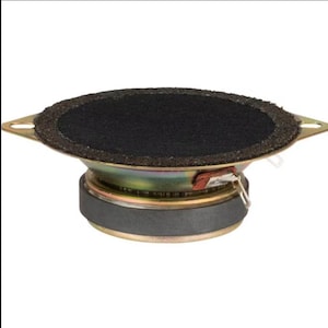 May include: A small, round speaker with a black, textured cone and a gold-colored metal frame. The speaker has a dark gray rubber surround and a red and silver connector. The speaker is designed for audio applications.