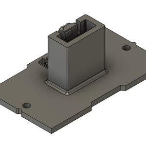 May include: A gray plastic connector with a rectangular base and a raised square section. The connector has a slot on the top and a small hole on the side.