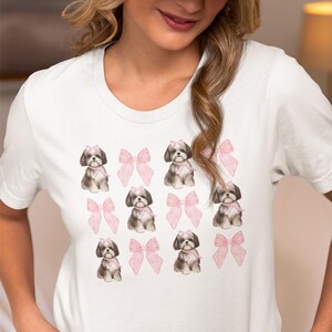 Show off your love for Shih Tzus with this adorable "Shih Tzu with Pink Bows" design! Available in T-Shirt, V-Neck, or Sweatshirt, this cute and playful graphic is perfect for Shih Tzu lovers who want to add a touch of sweetness to their wardrobe.