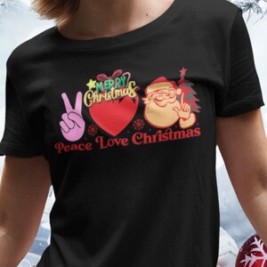 A woman wearing t-shirt with words Piece Love Christmas in Black Color