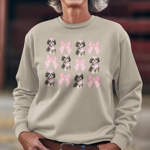 Show off your love for Shih Tzus with this adorable "Shih Tzu with Pink Bows" design! Available in T-Shirt, V-Neck, or Sweatshirt, this cute and playful graphic is perfect for Shih Tzu lovers who want to add a touch of sweetness to their wardrobe.