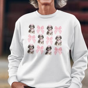 Show off your love for Shih Tzus with this adorable "Shih Tzu with Pink Bows" design! Available in T-Shirt, V-Neck, or Sweatshirt, this cute and playful graphic is perfect for Shih Tzu lovers who want to add a touch of sweetness to their wardrobe.