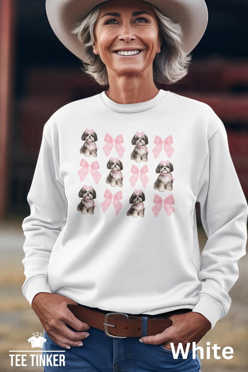 Show off your love for Shih Tzus with this adorable "Shih Tzu with Pink Bows" design! Available in T-Shirt, V-Neck, or Sweatshirt, this cute and playful graphic is perfect for Shih Tzu lovers who want to add a touch of sweetness to their wardrobe.