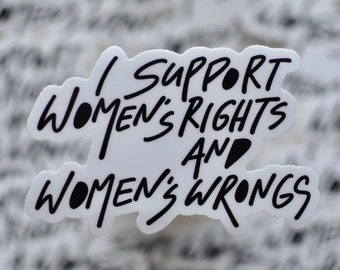 May include: White sticker with black text that reads "I support women's rights and women's wrongs".