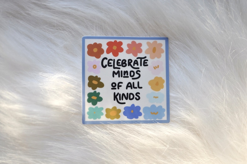 May include: A sticker with a blue border and a white background. The sticker features a colorful floral design with the text "Celebrate Minds of All Kinds" in black.