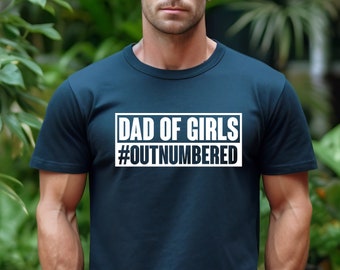 May include: A navy blue t-shirt with a white box that says "Dad of Girls #Outnumbered".