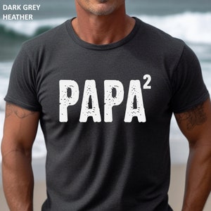 May include: Dark grey heather t-shirt with a white graphic that says "PAPA^2".