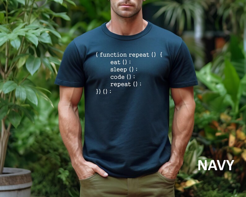 May include: Navy blue t-shirt with white text that reads "(function repeat () { eat (); sleep (); code (); repeat (); })() :". The word "NAVY" is printed in white at the bottom right corner. The shirt is a crew neck.