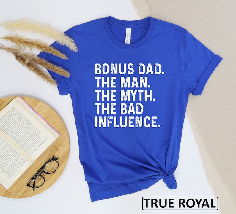 May include: Royal blue t-shirt with white text that reads "Bonus Dad. The Man. The Myth. The Bad Influence."