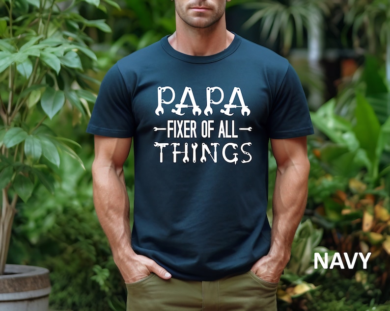 May include: A navy blue t-shirt with white text that reads "Papa - Fixer of All Things" with wrench and screwdriver graphics.