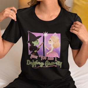 Wicked Defying Gravity T Shirt | Elphaba and Glinda