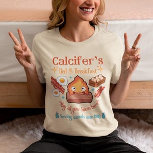 Howl’s Moving Castle Inspired Calcifer's Bed & Breakfast Unisex Softstyle T- Shirt , Anime Shirt, Howl and Sophie Shirt