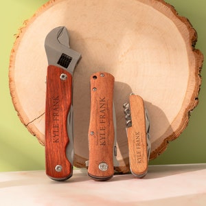 May include: Three personalized wooden handled tools, a wrench, a pocket knife, and a multi-tool, all with the name "KYLE FRANK" engraved on them.