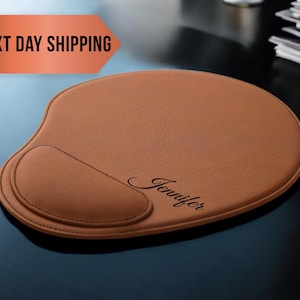 May include: A brown leather mouse pad with a wrist rest and the name "Jennifer" engraved in cursive.