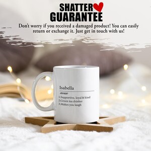 May include: White ceramic mug with a black design that says "Isabella noun 1. Supportive, loyal & kind 2. Green tea drinker 3. Makes you laugh"