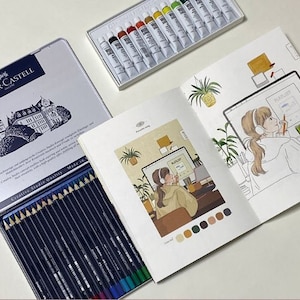 May include: A set of coloured pencils in a blue tin with the brand name Faber-Castell. The tin features a picture of a castle. The pencils are arranged in a row and labelled with their colours. The pencils are being used to colour a drawing of a person sitting at a desk with a computer. The drawing is in a sketchbook with a colour palette.