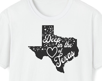 May include: White t-shirt with a black outline of the state of Texas. The outline includes a heart in the center with the text "Deep in the Heart of Texas".