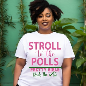 May include: White t-shirt with the text "Stroll to the Polls" in pink and "Pretty Girls Rock the Vote" in green.