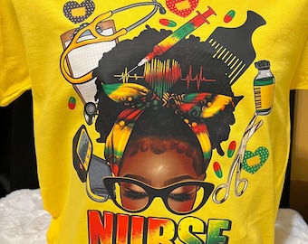 May include: Yellow t-shirt featuring a graphic of a Black woman with a nurse's cap and glasses, surrounded by medical tools. The word "NURSE" is printed in colorful letters, with "#Juneteenth" below.