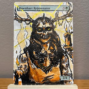 May include: A hand-painted trading card titled Dawnhart Rejuvenator featuring a skeletal figure with large antlers, yellow eyes, and dark hair. The artwork uses black ink lines and orange, yellow, and white paint, showing a 2/4 power and toughness.