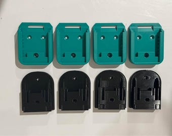 May include: Six 3D printed battery holders, three are teal green and three are black. The holders are designed to hold batteries for power tools.