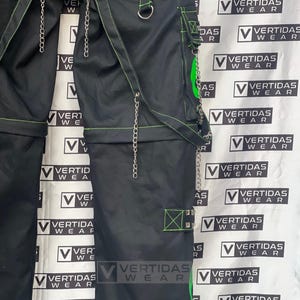 May include: Black cargo pants with green stitching and silver chains. The pants have multiple pockets and a mesh panel on the front. The pants are labeled "Vertidas Wear" on the side.