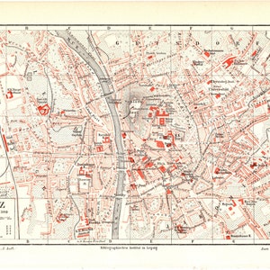 Könnte beinhalten: Eine Vintage-Karte von Graz, Österreich, in Rot und Schwarz gedruckt. Die Karte zeigt die Straßen, Gebäude und Sehenswürdigkeiten der Stadt, einschließlich der Mur. Die Karte trägt den Titel "GRAZ" und enthält das Datum "1:21300".