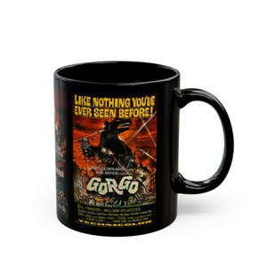 May include: A black ceramic mug featuring the vintage movie poster for Gorgo. The design displays the creature in a city, the text "LIKE NOTHING YOU'VE EVER SEEN BEFORE!", the title "GORGO", and production credits in yellow and white.
