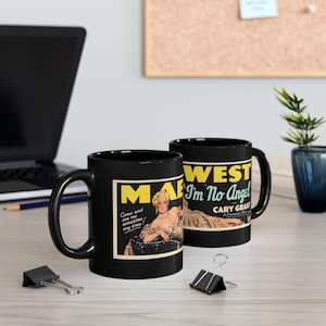 May include: Two black ceramic mugs featuring a vintage movie poster graphic for the film I'm No Angel starring Mae West and Cary Grant. The design includes the text Mae West, I'm No Angel, and the quote Come and see me sometime any time.