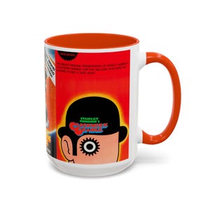 May include: White ceramic mug with an orange interior and handle. The mug features a graphic from Stanley Kubrick's "A Clockwork Orange" film, with text and a stylized image of a character.