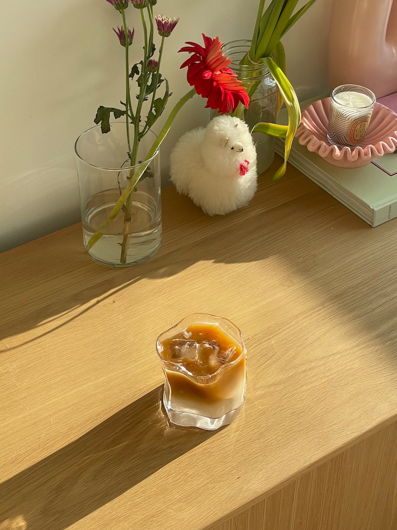 Handmade electroplated whiskey glasses with a wavy design, perfect for bourbon, cocktails, and iced coffee.