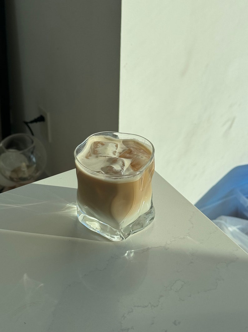 Electroplated bourbon and cocktail glasses set, featuring an irregular wavy design for a modern touch, great for serving iced coffee.