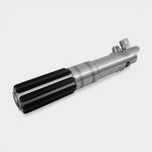 May include: A silver lightsaber with black grips. The hilt features a cylindrical design with detailed ridges and a textured grip section. The top of the hilt has several small, detailed components.
