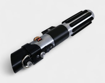 May include: A replica lightsaber with a black handle, silver accents, and a detailed emitter. The hilt features various buttons, switches, and a ring at the base. The top has a silver finish with black ridges. A prop from a science fiction movie.