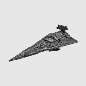 May include: A detailed, metallic gray model of a Star Destroyer spaceship. The model features intricate surface detailing, a prominent bridge structure, and a sharply angled hull. The spaceship is set against a plain white background.