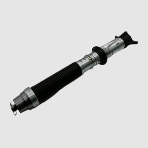 May include: A black and silver telescopic fishing rod with a black rubber grip and a silver metal tip. The rod is extended to its full length.