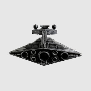 May include: A detailed, dark gray model of a Star Destroyer spaceship. The model features intricate detailing, including multiple circular engine ports and a prominent bridge structure with spherical elements. The ship's design is angular and symmetrical.