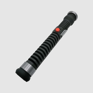 May include: A black lightsaber with a silver band and a red button. The lightsaber has a textured, ribbed design.