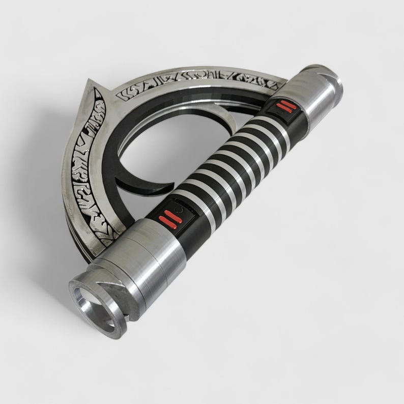 May include: A silver lightsaber with a black handle and a circular, engraved guard. The handle has black and silver stripes and two red buttons.