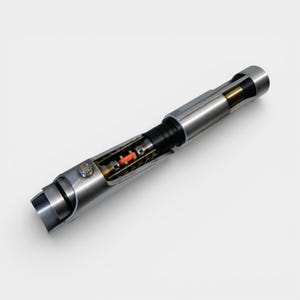 May include: A silver lightsaber with a detailed cross-section view. The hilt is metallic with a black grip and a visible internal mechanism featuring red and gold components. The design suggests a futuristic or sci-fi theme.