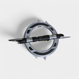 May include: A silver and black lightsaber with a circular handle and a sharp blade. The lightsaber is mounted on a stand.